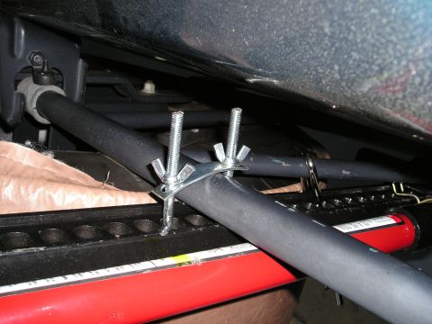 1996 Ford Bronco - Custom clamp installation under a seat, showing hardware and tubing.