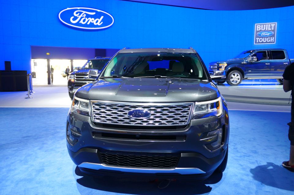 Front view of a dark gray Ford Explorer SUV with a blue Ford logo on the grille.