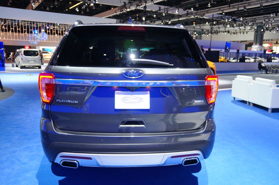 Rear view of a dark gray Ford Explorer Platinum with 'EXPLORER' lettering and blue Ford badge.