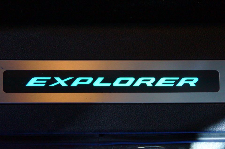 Illuminated "EXPLORER" text on a vehicle door sill.