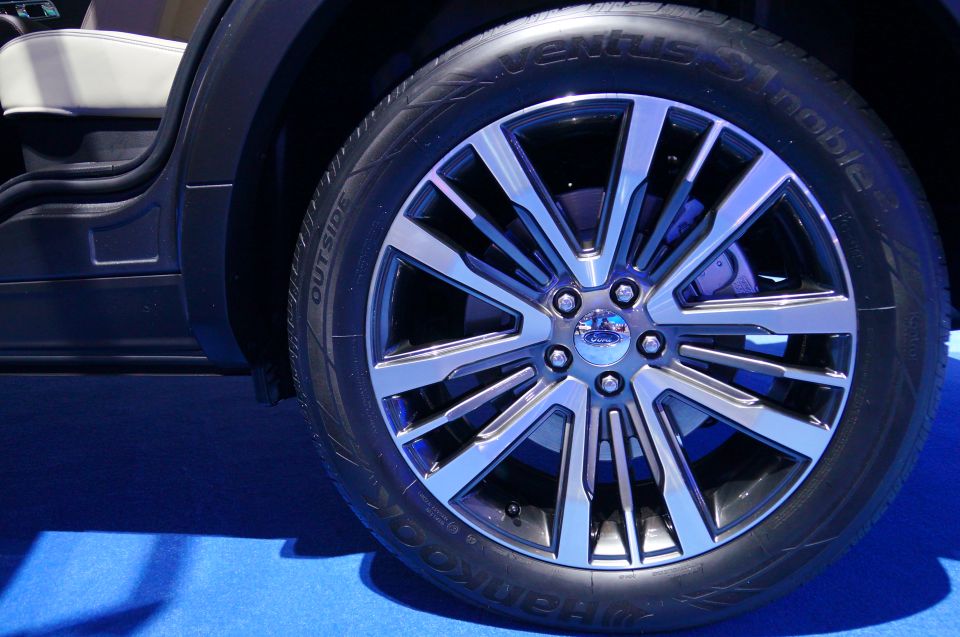 Close-up of a Ford vehicle's alloy wheel and tire.