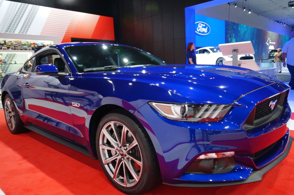 Blue Ford Mustang on display at an auto show.