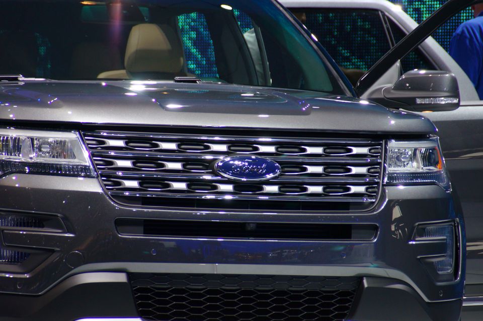 Front view of a dark gray Ford Explorer SUV with chrome grille and headlights.