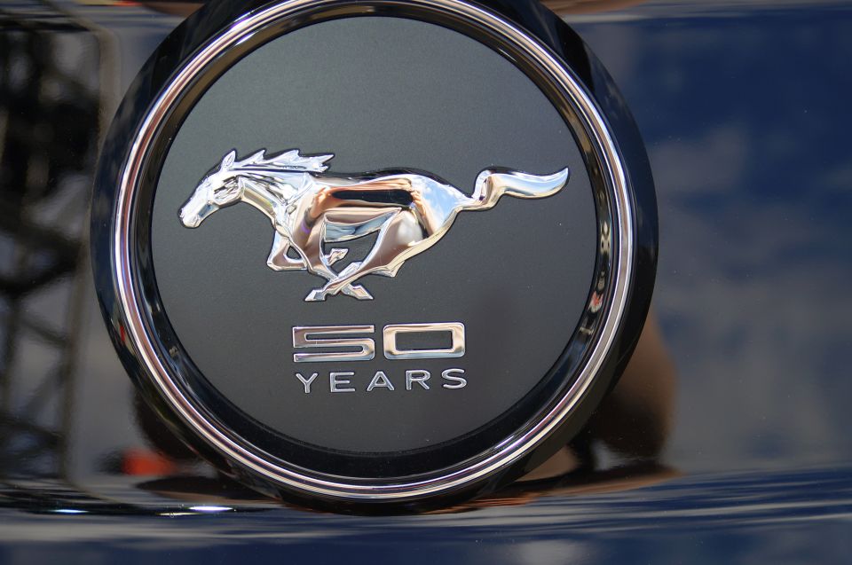 Ford Mustang 50 Years emblem with running horse and text