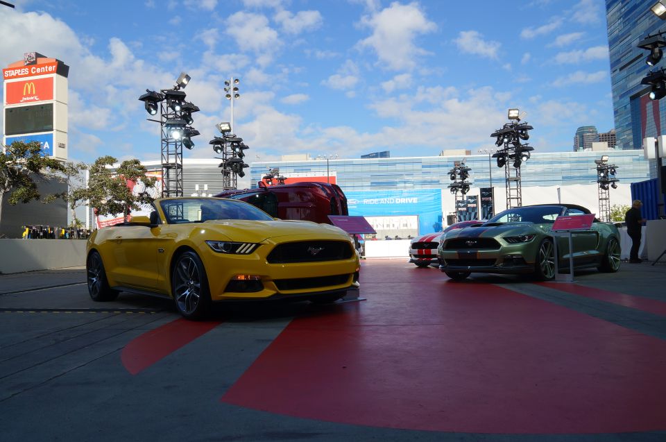 Yellow and green Ford Mustang convertibles parked outside Staples Center.