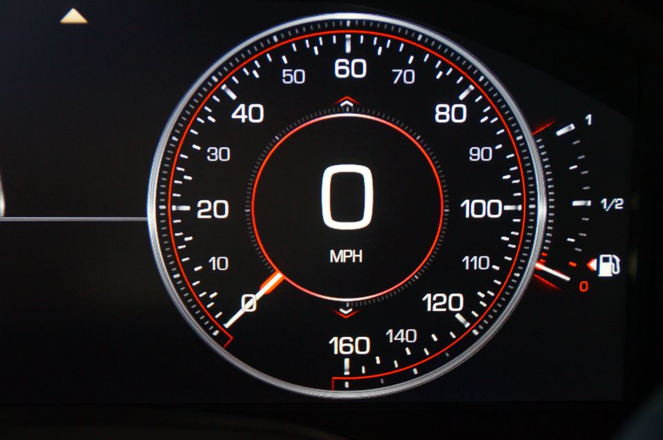 Digital car speedometer showing 0 MPH with fuel gauge.