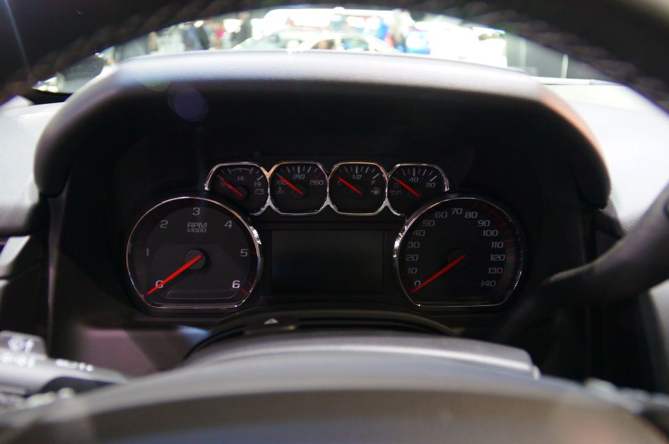 Close-up of a car dashboard with multiple gauges.