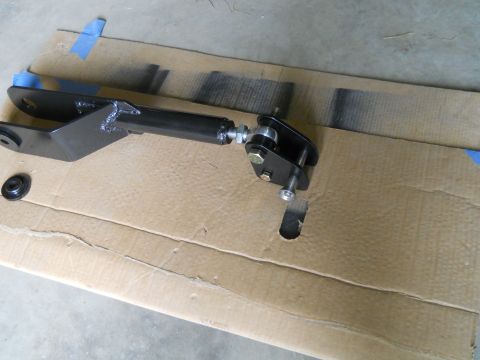 1992 Ford Bronco - A black adjustable control arm with silver hardware is shown resting on a piece of cardboard with blue tape. Some black spray paint marks a…