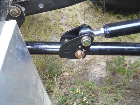 1992 Ford Bronco - A close-up view shows a black metal rod connected to a black bracket with two bolts. The rod appears to be part of a vehicle's suspension o…