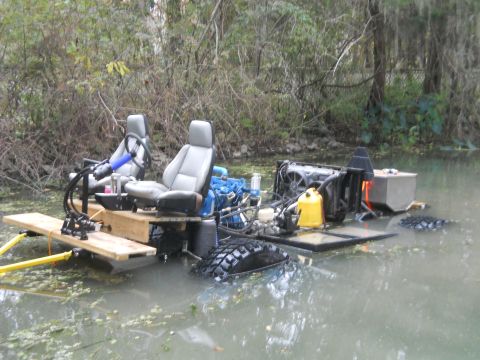 1992 Ford Bronco - A custom-built amphibious vehicle with two seats and a visible engine sits in murky water surrounded by vegetation. The vehicle appears to…