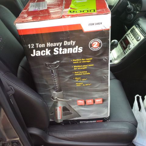 1978 Ford Bronco - A box of jack stands is placed on the passenger seat of a car.