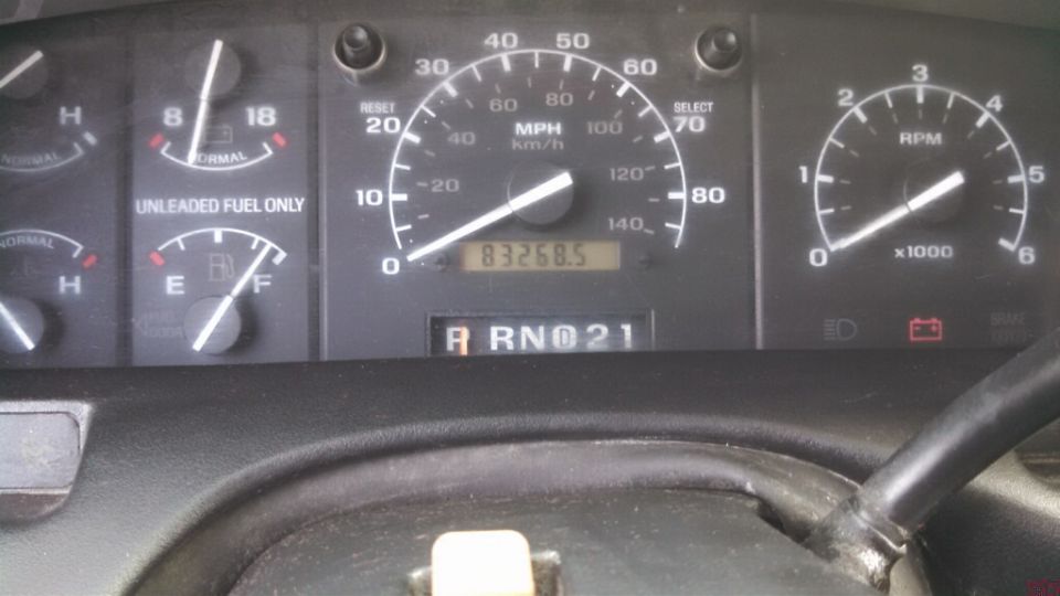 1995 Ford Bronco dashboard with speedometer, fuel gauge, and RPM gauge visible. Odometer shows 83268.5 miles