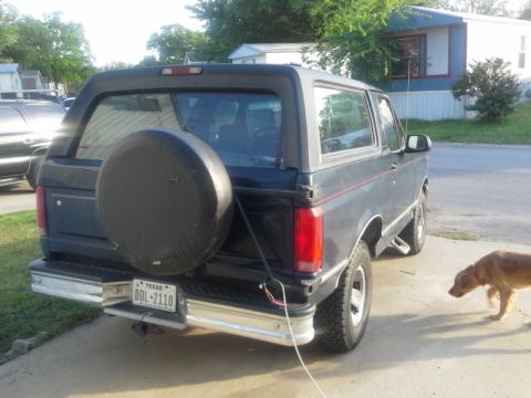 1993 Ford Bronco - The rear view of a Ford Bronco, showing its spare tire and Texas license plate.