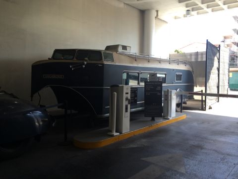 1968 Ford Mustang - A vintage bus, labeled "VAGABOND," is parked next to charging stations.