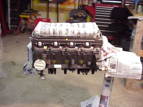 1989 Ford Bronco - Engine block covered in newspaper, likely for protection during a rebuild or painting.