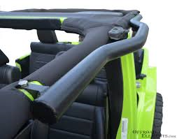 1979 Ford Bronco - Close-up view of the interior of a green Jeep, highlighting the roll cage and black seats.