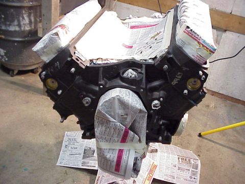 1989 Ford Bronco - Engine block prepared with newspaper for painting or storage.