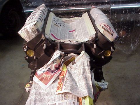 1989 Ford Bronco - Engine block covered in newspaper, likely for protection during a rebuild or storage.