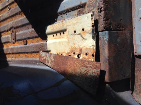 1979 Ford Bronco - Close-up of heavily rusted metal panels, showing signs of significant wear and tear.