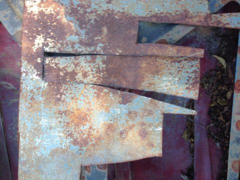 1979 Ford Bronco - Close-up of heavily rusted metal panels, obscuring any clear view of a vehicle.