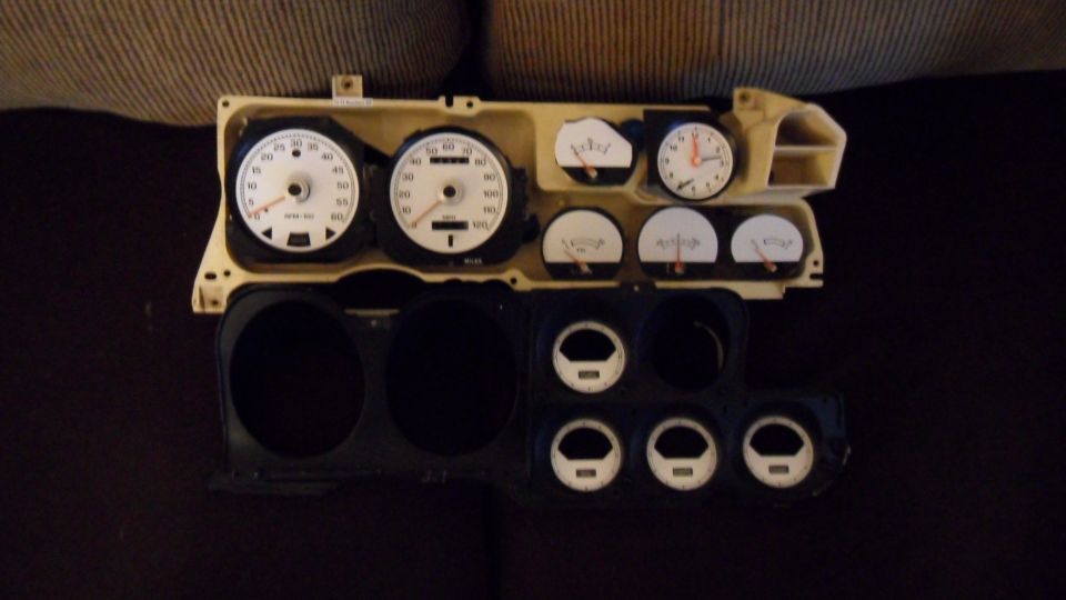 car dashboard with speedometer, tachometer, clock, and other gauges