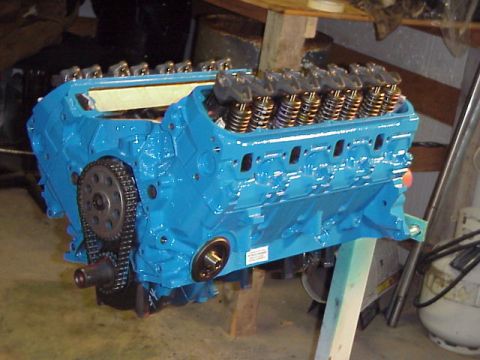 1989 Ford Bronco - Engine block painted blue, showing timing chain and valve train components.