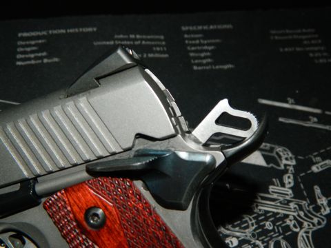 1979 Ford Bronco - A detailed view of a pistol's operational components and checkered grip.