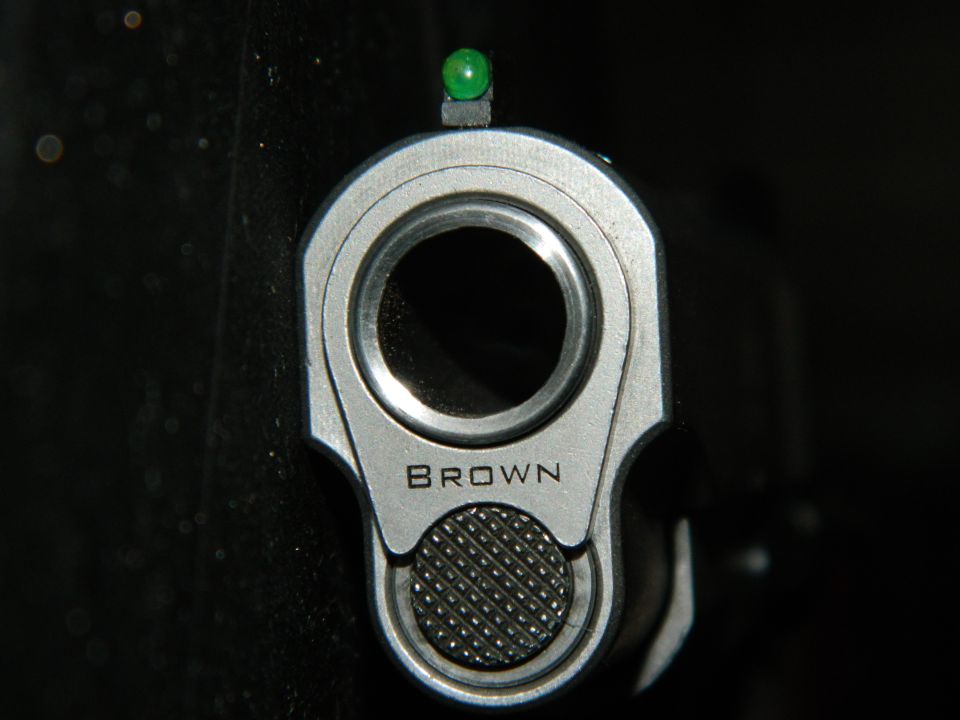 Gun barrel with green front sight and the word BROWN engraved