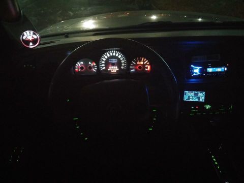 2000 Mercury Grand Marquis - Dashboard of a 2000 Mercury Grand Marquis at night with glowing gauges and aftermarket stereo.