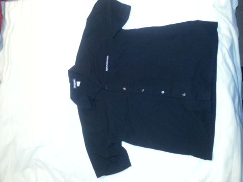 2003 Mercury Marauder - A black short-sleeved button-up shirt with "MARAUDER" text is laid out on a white surface.