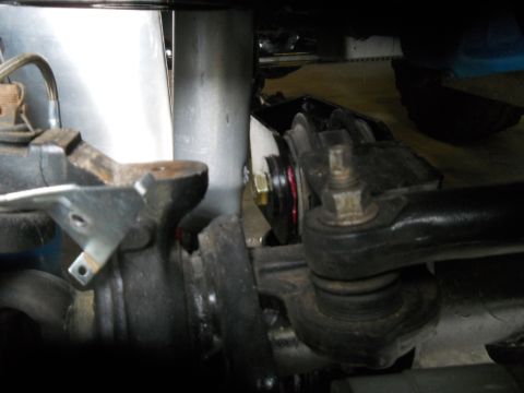 1992 Ford Bronco - Close-up view of vehicle suspension components, showing a ball joint and various metal parts.