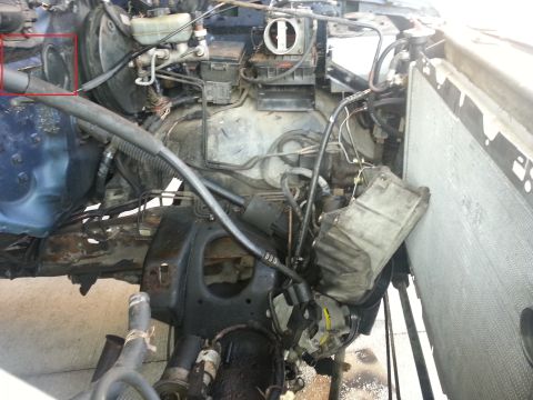 1994 Ford Bronco - Close-up view of a vehicle's engine bay, showing various mechanical parts and wiring.
