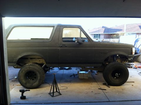 1995 Ford Bronco - This Ford Bronco appears to be in a garage, possibly being worked on, with its wheels off the ground.