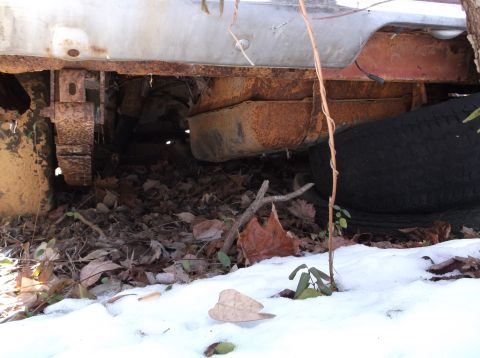 1974 Dodge Challenger - This car's undercarriage is heavily rusted, with a spare tire visible near the rear.
