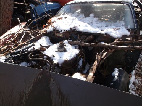 1974 Dodge Challenger - This car is in a junkyard, covered in snow and debris, with its engine exposed.