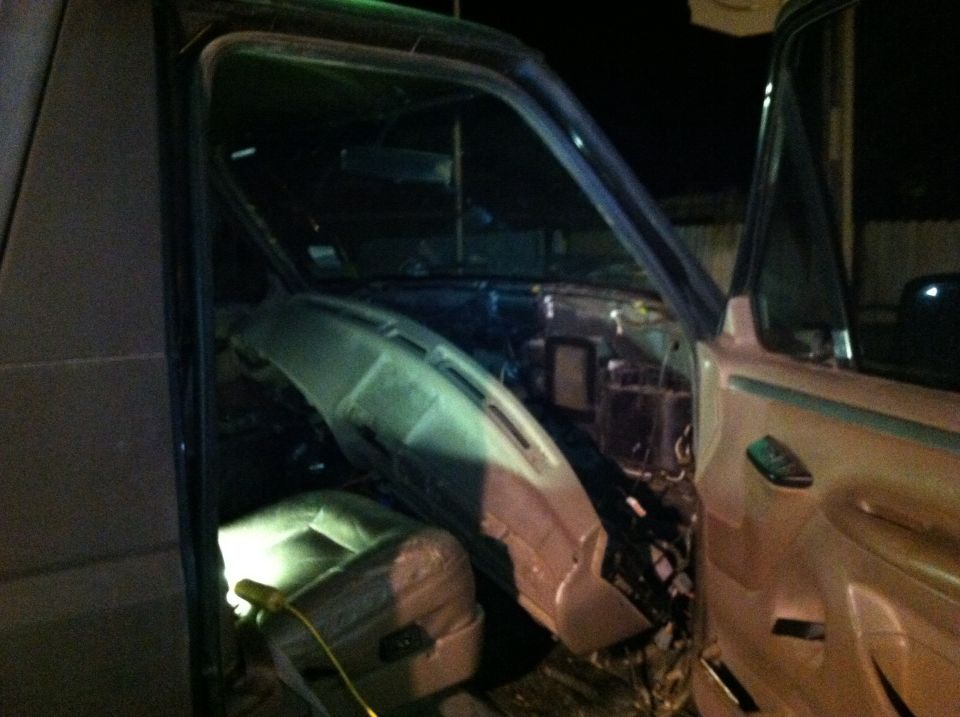 1995 Ford Bronco interior with dashboard removed and seats exposed
