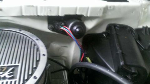 1982 Ford Bronco - Close-up view of an engine bay, a chrome air cleaner and a black motor with colorful wires.