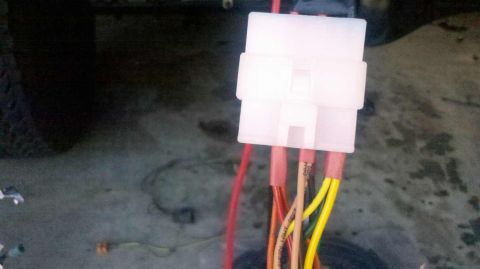 1982 Ford Bronco - Close-up of a white electrical connector with multiple colored wires, including a SuperMotors watermark.