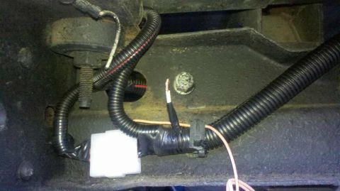 1982 Ford Bronco - Vehicle wiring harness and frame detail, showing electrical connections and protective tubing.