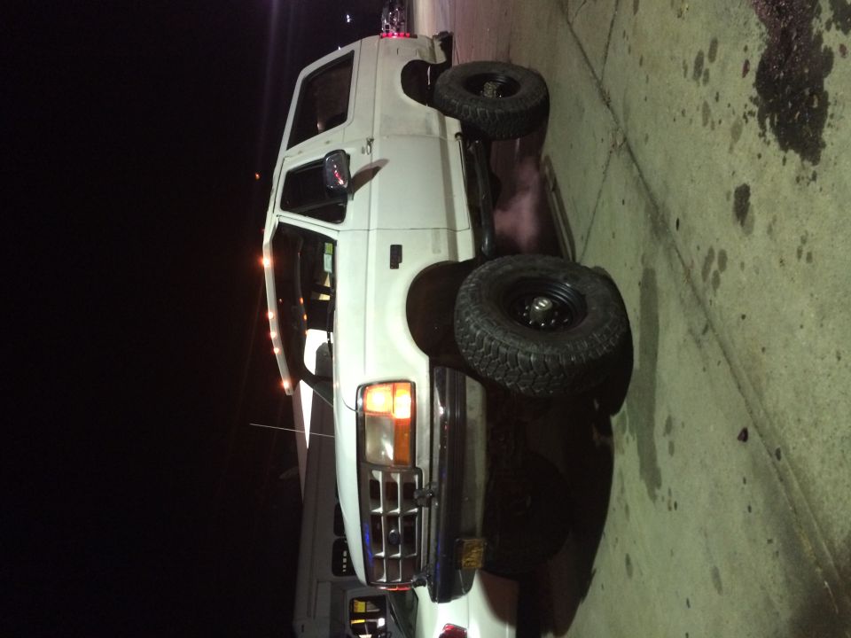 White van with large tires parked on concrete