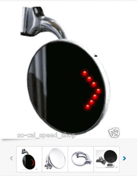 1964 Ford Ranchero - Close-up of a round side mirror with a red LED arrow turn signal indicator.