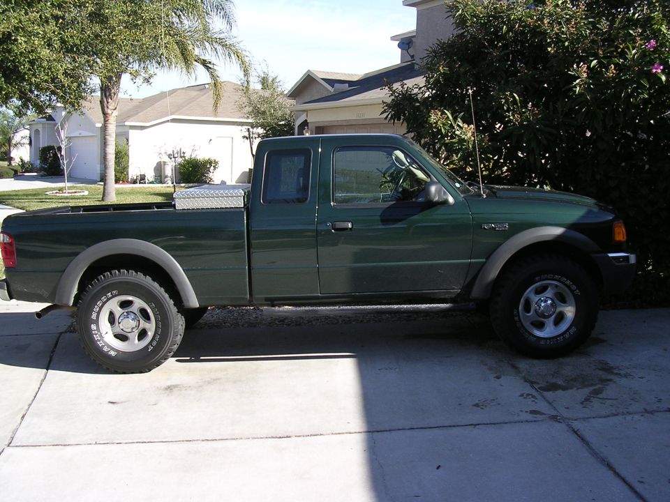 Green Ford Ranger pickup truck parked in a driveway