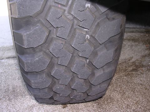 1985 Ford Bronco - This image shows the tread pattern of an off-road tire, with visible cracks in the rubber blocks.