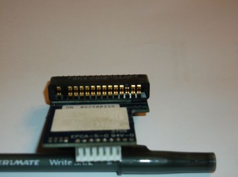 1979 Ford Ranchero - A close-up of an electronic connector with gold pins and markings indicating 'SN 862500336' and 'EPCA-S-D 94V-0'. A black pen with 'ER-MATE…