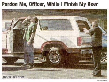 1990 Ford Bronco - Officer confronts man drinking beer next to a 1990 Ford Bronco.