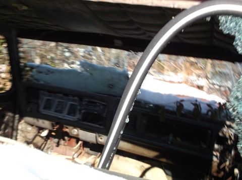 1974 Dodge Challenger - Interior view of a 1974 Dodge Challenger, showing a snow-covered dashboard and a cracked windshield.