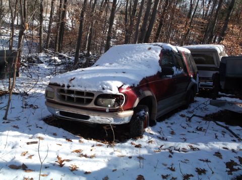 1974 Dodge Challenger - A red pickup truck sits parked in a snowy outdoor setting.