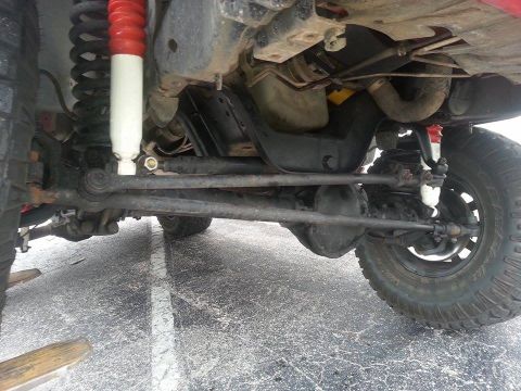 1995 Ford Bronco - This photo shows the underside of a 4x4 vehicle, focusing on the steering and suspension system.