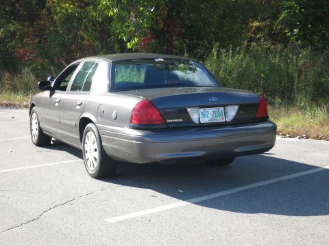 2001 Ford Crown Victoria - Grey Ford Crown Victoria with license plate 362 2004 is parked outdoors.