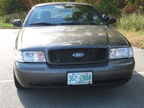 2001 Ford Crown Victoria - Front view of a grey Ford Crown Victoria, displaying a 2004 license plate from New Hampshire.